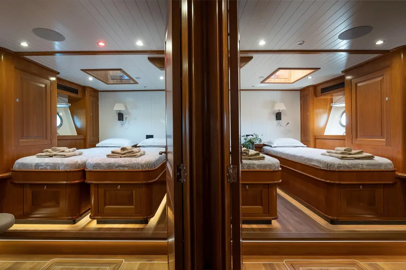 Melody Yacht Photos Pics Luxurious 2022 Ridas Custom Yacht cabin with elegant wood finish and twin beds.