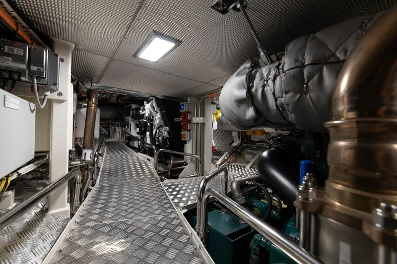 Melody Yacht Photos Pics Engine room of 2022 Ridas Custom Yacht, featuring modern equipment and metallic walkway.