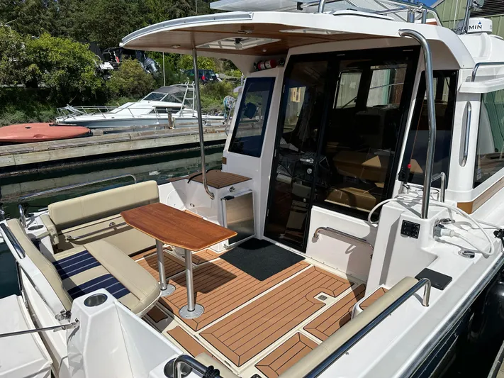  Yacht Photos Pics 2023 Ranger Tugs R-29 S with elegant outdoor deck and wood flooring.
