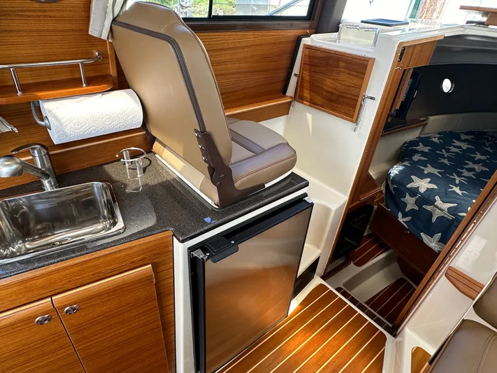  Yacht Photos Pics Interior of 2023 Ranger Tugs R-29 S yacht with kitchen and sleeping area.