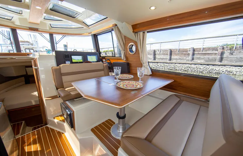  Yacht Photos Pics Interior of 2023 Ranger Tugs R-29 S yacht with dining table and seating area.