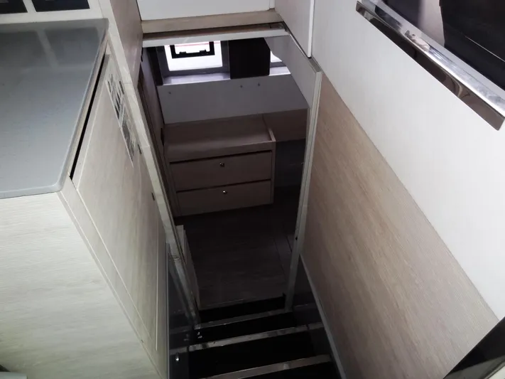 Aquaholic Yacht Photos Pics Interior stairs of 2019 Leopard 50 yacht leading to lower cabin with drawers.
