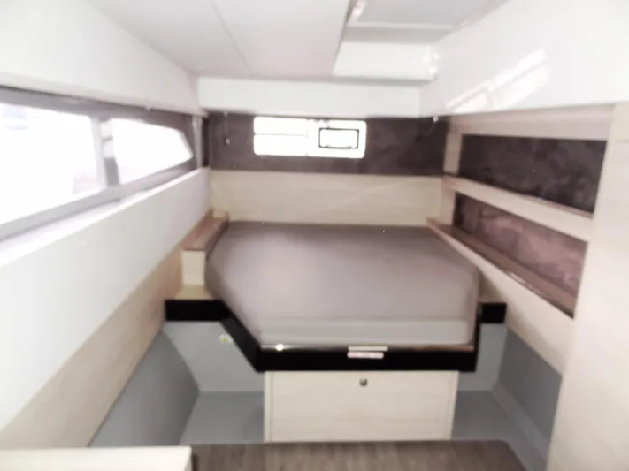 Aquaholic Yacht Photos Pics 2019 Leopard 50 yacht interior cabin with bed and storage shelves.