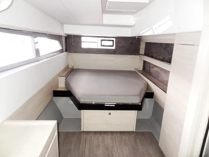 Aquaholic Yacht Photos Pics Modern bedroom interior of 2019 Leopard 50 yacht with bed and storage shelves.