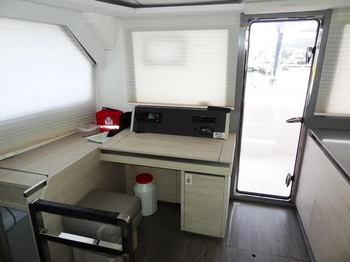 Aquaholic Yacht Photos Pics Interior of a 2019 Leopard 50 yacht with navigation station and door to deck.