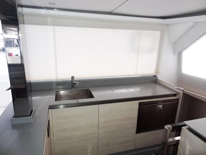 Aquaholic Yacht Photos Pics Modern kitchen interior on a 2019 Leopard 50 yacht with sleek countertops and cabinetry.