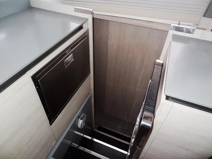 Aquaholic Yacht Photos Pics Modern interior of 2019 Leopard 50 yacht with sleek cabinetry and stairs.