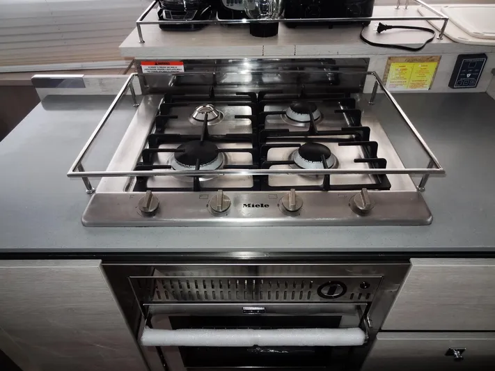 Aquaholic Yacht Photos Pics Stainless steel gas stove and oven in a 2019 Leopard 50 yacht kitchen.