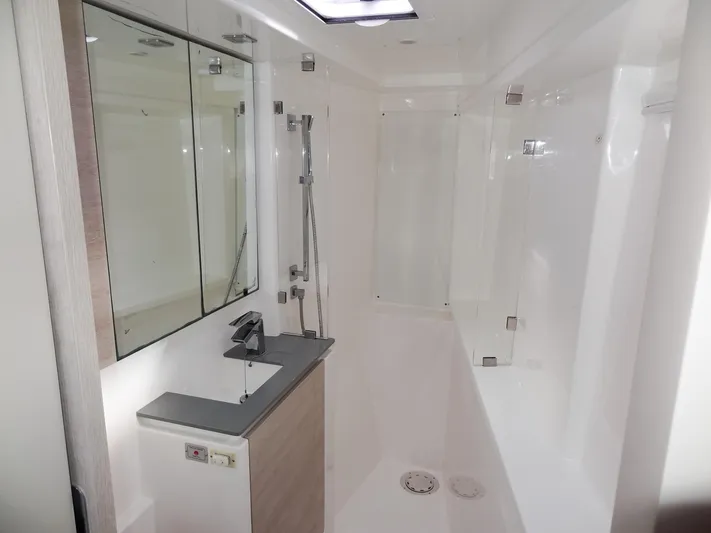 Aquaholic Yacht Photos Pics Modern bathroom in 2019 Leopard 50 yacht with sleek fixtures and mirrored cabinets.