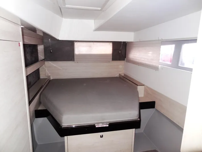 Aquaholic Yacht Photos Pics Modern bedroom interior of 2019 Leopard 50 yacht with bed and windows.