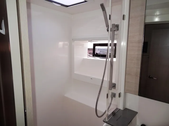 Aquaholic Yacht Photos Pics Modern shower area in 2019 Leopard 50 yacht with sleek fixtures and window.