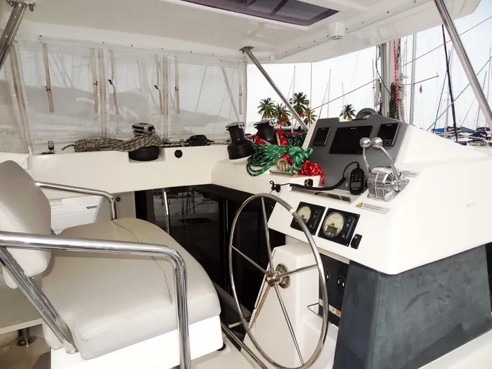 Aquaholic Yacht Photos Pics 2019 Leopard 50 yacht helm station with steering wheel and navigation controls.