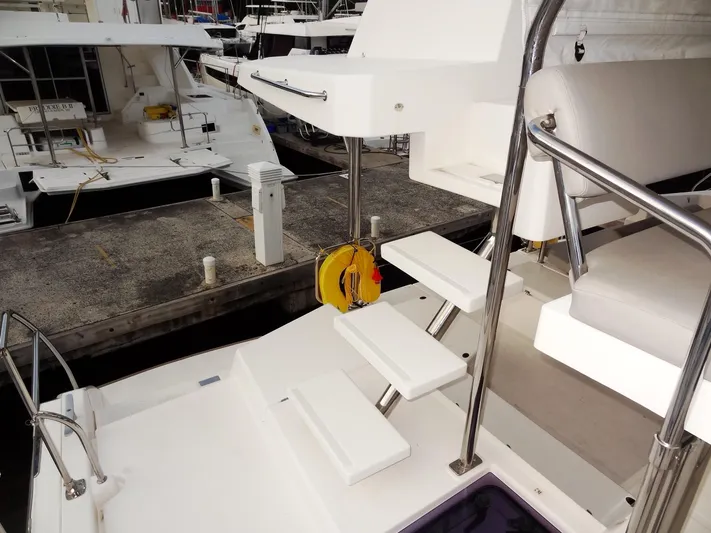 Aquaholic Yacht Photos Pics 2019 Leopard 50 yacht docked, featuring white steps and stainless steel railings.