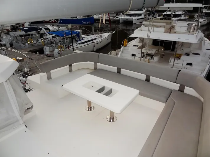 Aquaholic Yacht Photos Pics Flybridge seating area on a 2019 Leopard 50 yacht in a marina.