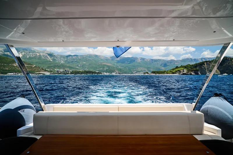  Yacht Photos Pics 2023 Ferretti Yachts 920 cruising with scenic mountain and ocean view.