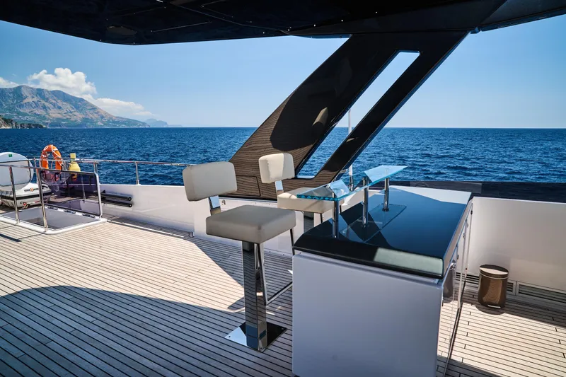  Yacht Photos Pics Luxurious 2023 Ferretti Yachts 920 deck with bar stools and ocean view.