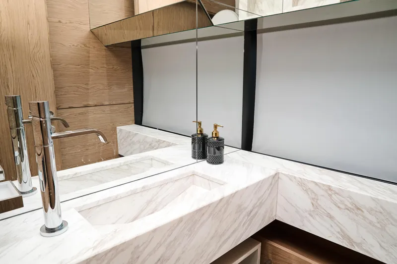  Yacht Photos Pics Luxurious bathroom in 2023 Ferretti Yachts 920, featuring marble countertops and modern fixtures.
