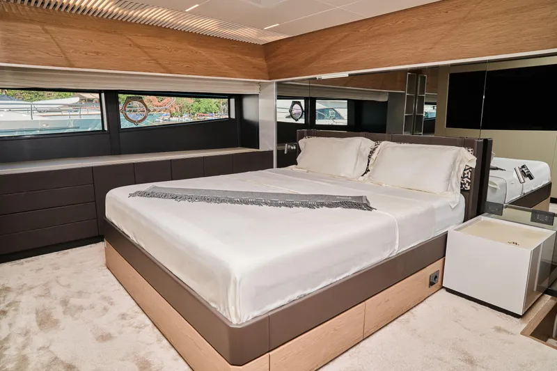  Yacht Photos Pics Luxurious bedroom interior of 2023 Ferretti Yachts 920 with modern design and large windows.