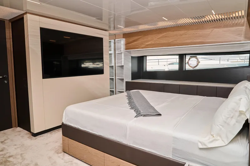  Yacht Photos Pics Luxurious bedroom interior of 2023 Ferretti Yachts 920 with modern design and large window.