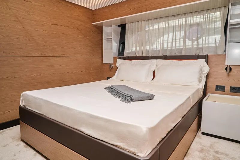  Yacht Photos Pics Luxurious bedroom interior of 2023 Ferretti Yachts 920 with modern design and cozy bedding.