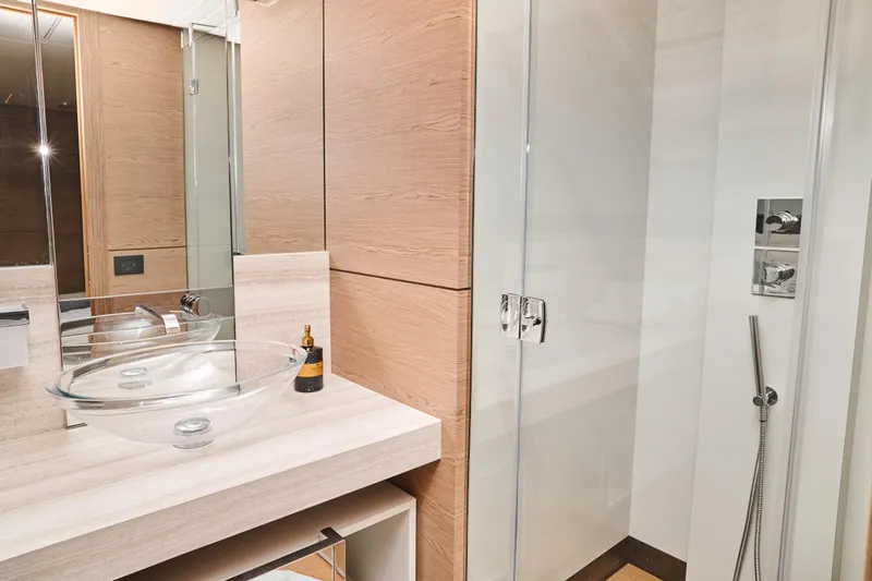  Yacht Photos Pics Luxurious bathroom in 2023 Ferretti Yachts 920, featuring glass sink and modern shower.
