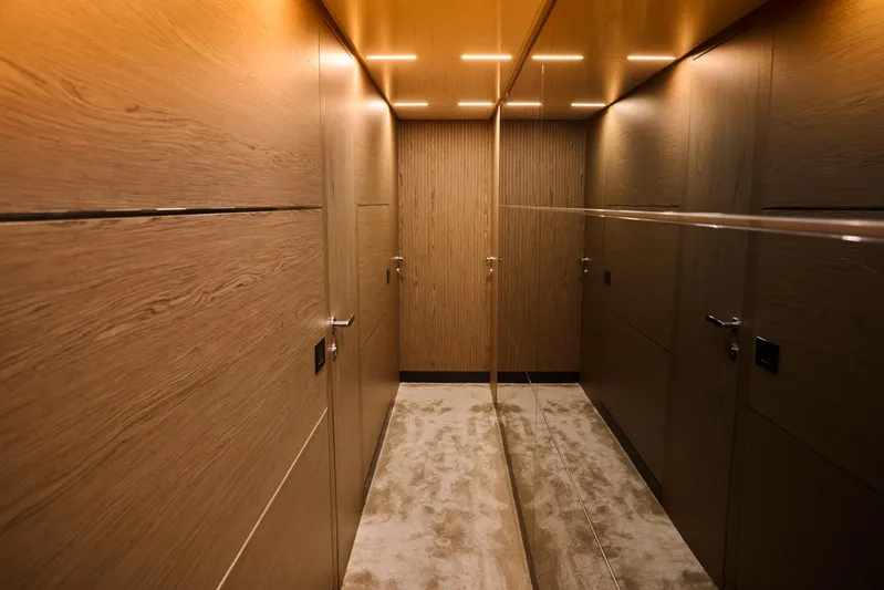  Yacht Photos Pics Luxurious wooden interior hallway of 2023 Ferretti Yachts 920, featuring elegant lighting.