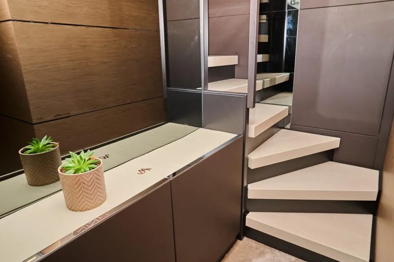  Yacht Photos Pics Luxurious interior of 2023 Ferretti Yachts 920 with modern staircase and elegant decor.
