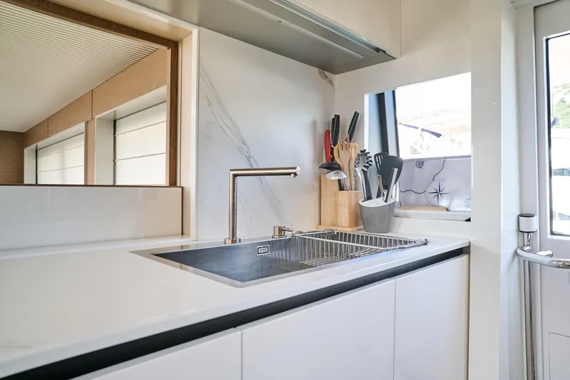  Yacht Photos Pics Modern kitchen interior on 2023 Ferretti Yachts 920, featuring sleek design and stainless steel sink.