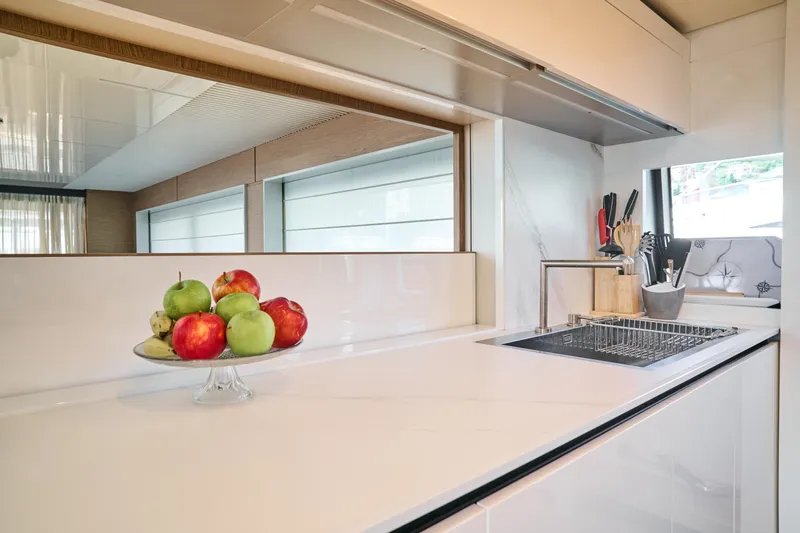  Yacht Photos Pics Modern kitchen interior on 2023 Ferretti Yachts 920, featuring sleek countertops and fruit display.