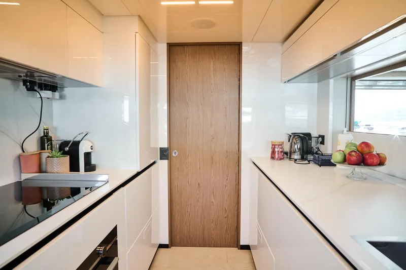  Yacht Photos Pics Modern kitchen interior on 2023 Ferretti Yachts 920, featuring sleek cabinetry and appliances.