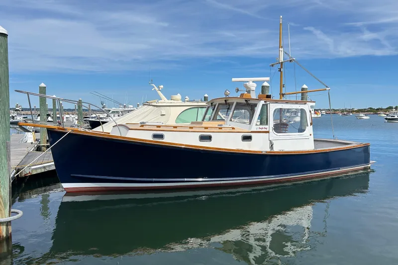 Bugle Boy Yacht Photos Pics Classic 1994 John Williams Stanley 36 boat docked in a serene marina setting.