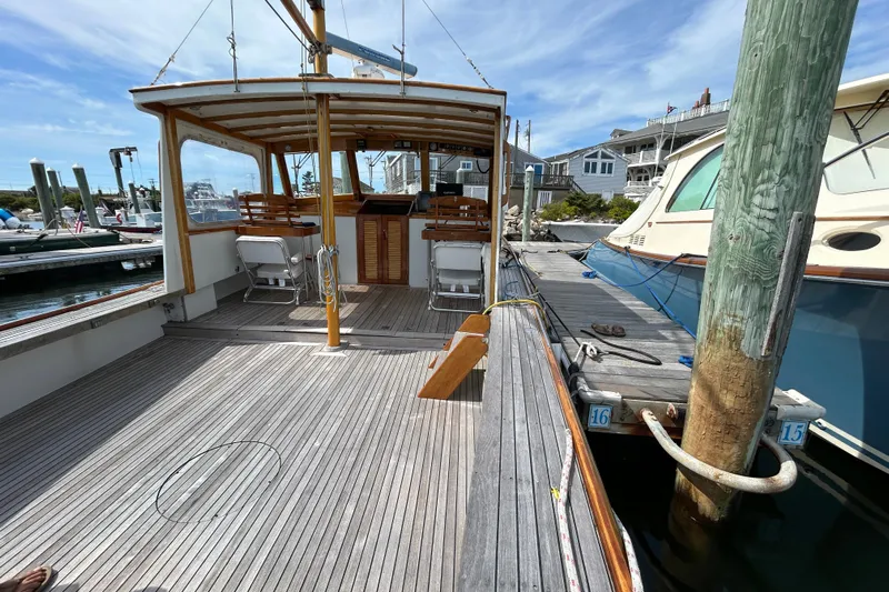 Bugle Boy Yacht Photos Pics Wooden deck of a 1994 John Williams Stanley 36 boat docked at a marina.