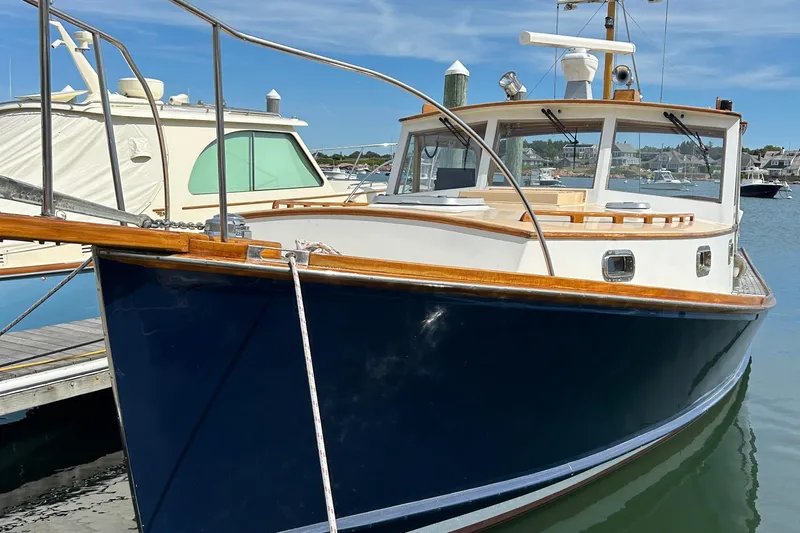 Bugle Boy Yacht Photos Pics 1994 John Williams Stanley 36 boat docked in a marina under clear blue skies.