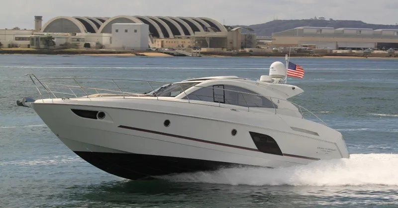 Be Water My Friend Yacht Photos Pics 2016 Beneteau GT49 yacht cruising on water near industrial buildings.