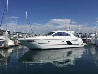 Be Water My Friend Yacht Photos Pics 2016 Beneteau GT49 yacht docked in a marina under a clear blue sky.