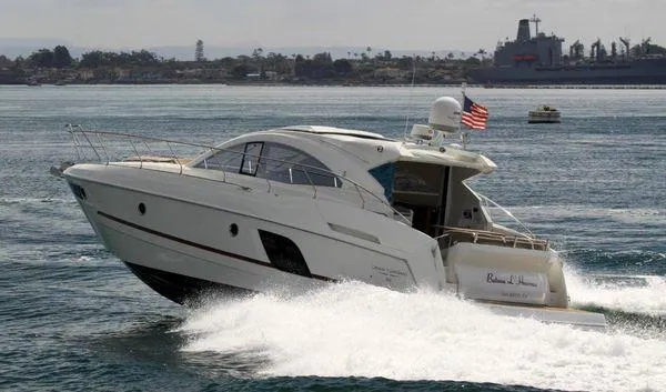 Be Water My Friend Yacht Photos Pics 2016 Beneteau GT49 yacht cruising on open water, American flag waving.