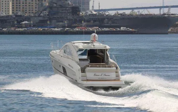 Be Water My Friend Yacht Photos Pics 2016 Beneteau GT49 yacht cruising on water with cityscape background.