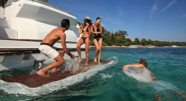 Be Water My Friend Yacht Photos Pics People enjoying water activities near a 2016 Beneteau GT49 yacht.