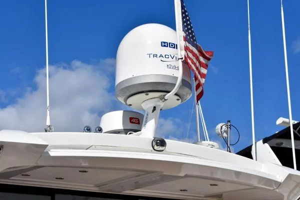 Be Water My Friend Yacht Photos Pics 2016 Beneteau GT49 yacht with radar equipment and American flag against blue sky.