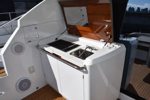 Be Water My Friend Yacht Photos Pics Outdoor kitchenette on 2016 Beneteau GT49 yacht with sink and stove.