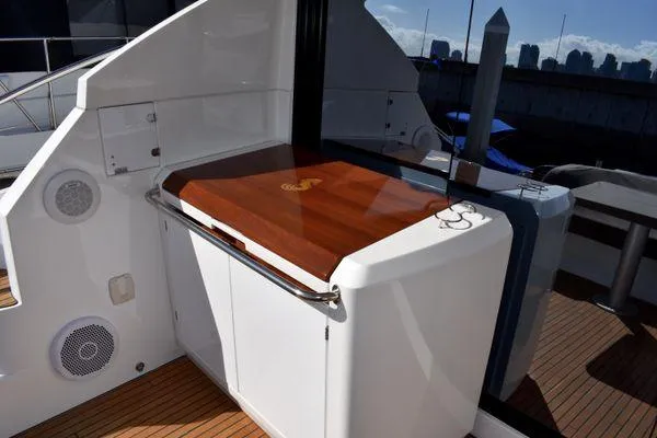 Be Water My Friend Yacht Photos Pics 2016 Beneteau GT49 yacht deck with wooden table and sleek design.