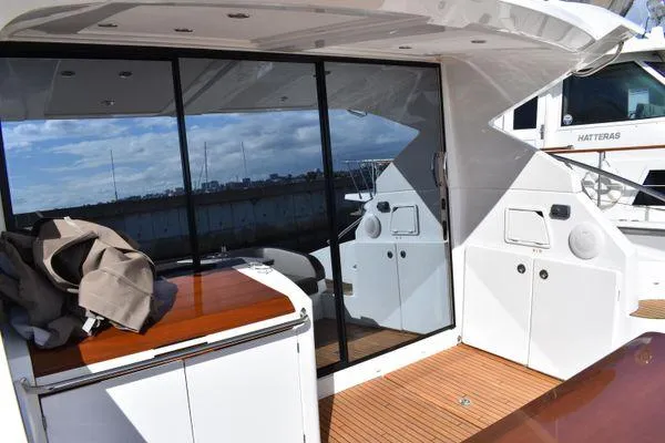 Be Water My Friend Yacht Photos Pics 2016 Beneteau GT49 yacht deck with glass doors and wooden flooring.