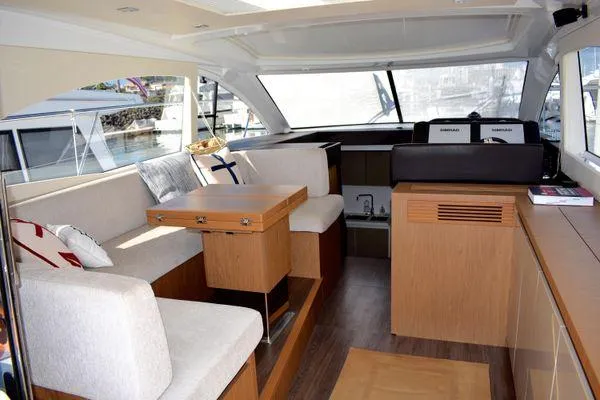 Be Water My Friend Yacht Photos Pics Luxurious interior of 2016 Beneteau GT49 yacht with modern seating and wooden finishes.