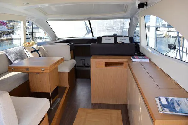Be Water My Friend Yacht Photos Pics Interior of 2016 Beneteau GT49 yacht with modern seating and wooden cabinetry.
