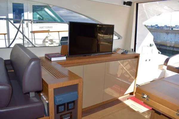 Be Water My Friend Yacht Photos Pics Interior of 2016 Beneteau GT49 yacht with TV, seating, and cabinetry.