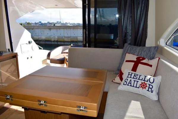 Be Water My Friend Yacht Photos Pics Interior of 2016 Beneteau GT49 yacht with cozy seating and nautical-themed decor.