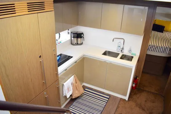 Be Water My Friend Yacht Photos Pics Modern kitchen interior on 2016 Beneteau GT49 yacht, featuring sleek cabinetry and appliances.