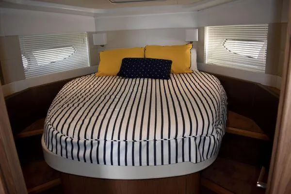 Be Water My Friend Yacht Photos Pics 2016 Beneteau GT49 yacht bedroom with striped bedding and yellow pillows.