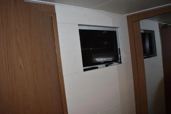 Be Water My Friend Yacht Photos Pics Interior view of 2016 Beneteau GT49 yacht with wooden paneling and window.