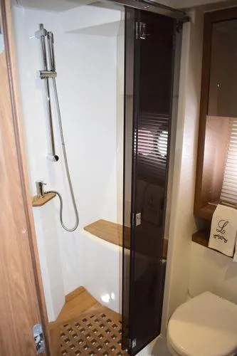 Be Water My Friend Yacht Photos Pics 2016 Beneteau GT49 yacht bathroom with shower, wooden accents, and modern fixtures.